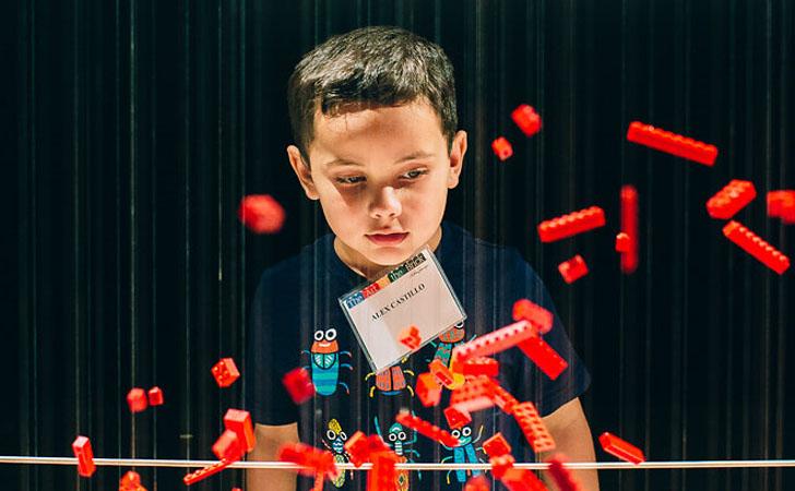 Young boy watching falling legos